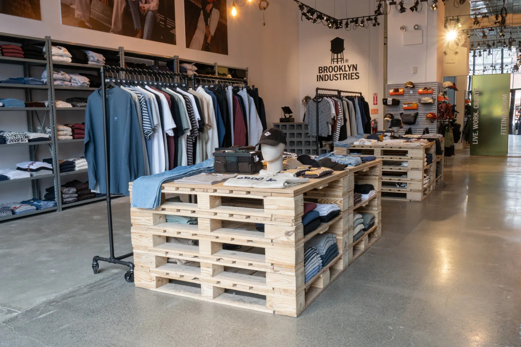 Timber display tables, metal rails and the Brooklyn Industries identity in the Williamsburg flagship.