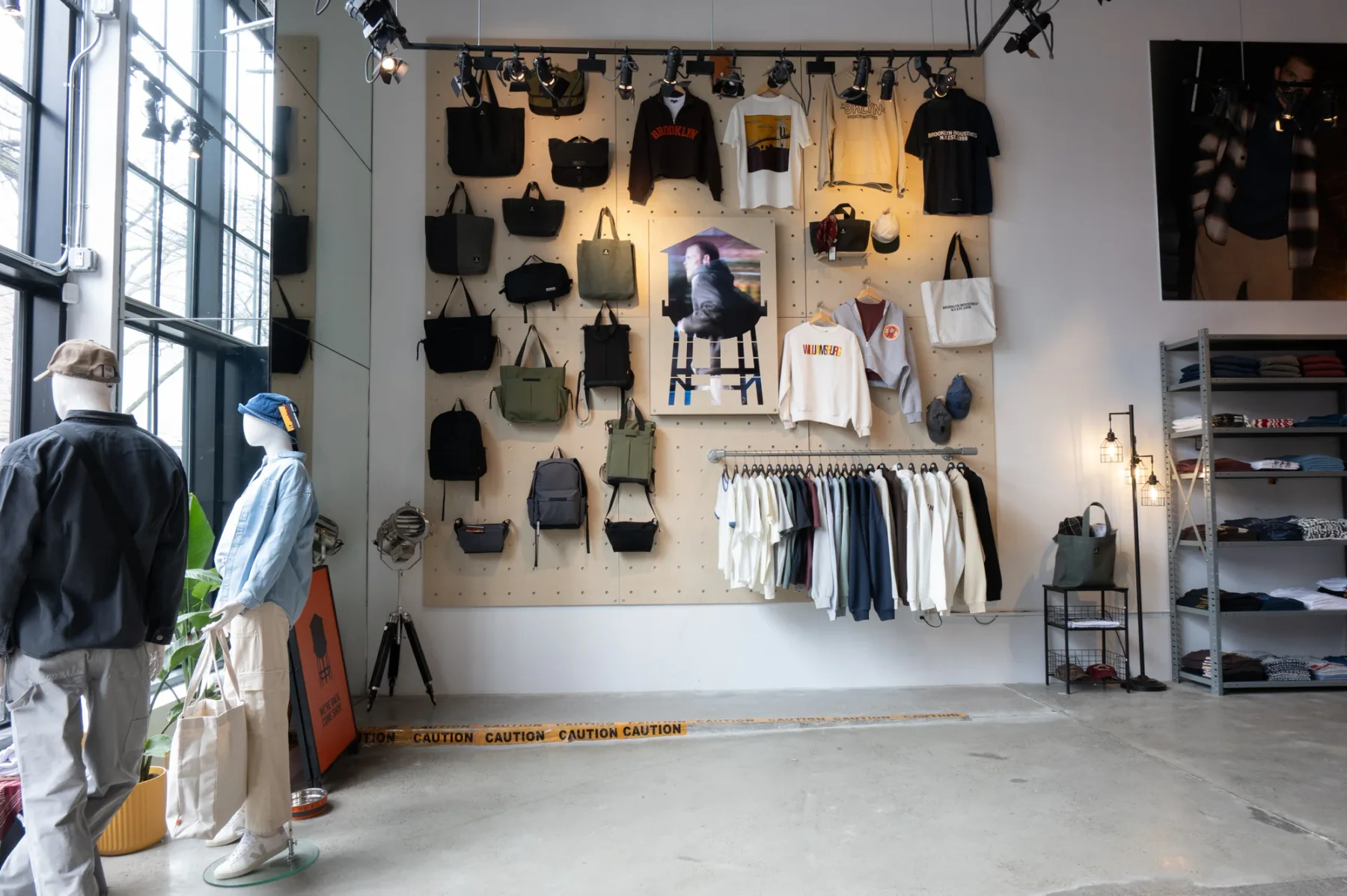 Apparel and accessories arranged along the Brooklyn Industries Williamsburg merchandise wall