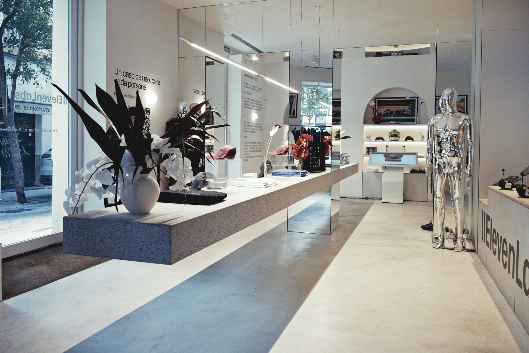 Mirrored walls, a floating product counter and chrome mannequin in the ElevenLabs Madrid interior