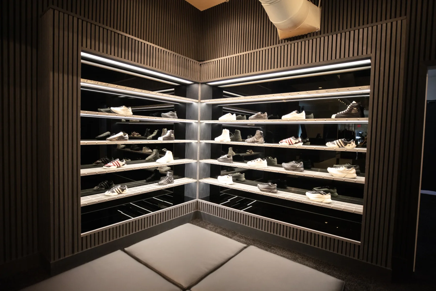 Illuminated footwear shelving, slatted wall finishes and seating inside Y-3 SoHo