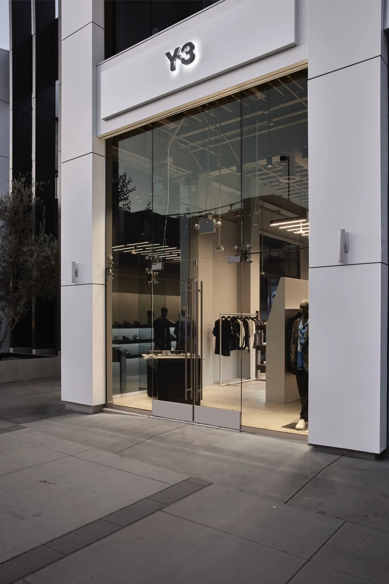 The glass storefront and illuminated Y-3 entrance on Melrose Avenue, West Hollywood